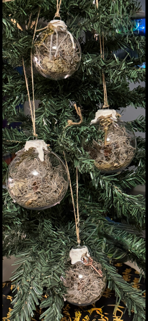 Handmade Cleansing Witch Balls hanging on a decorative tree