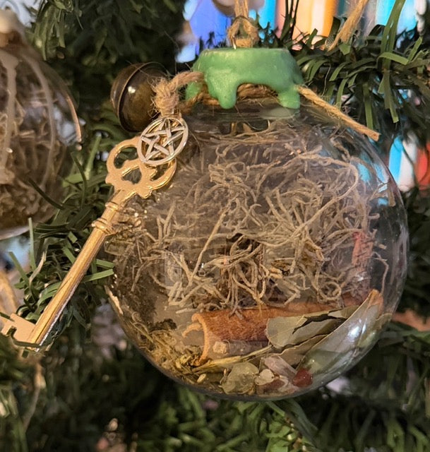 Close view of the Abundance and Prosperity Witch Ball with its green wax seal, jute twine, and brass key charm